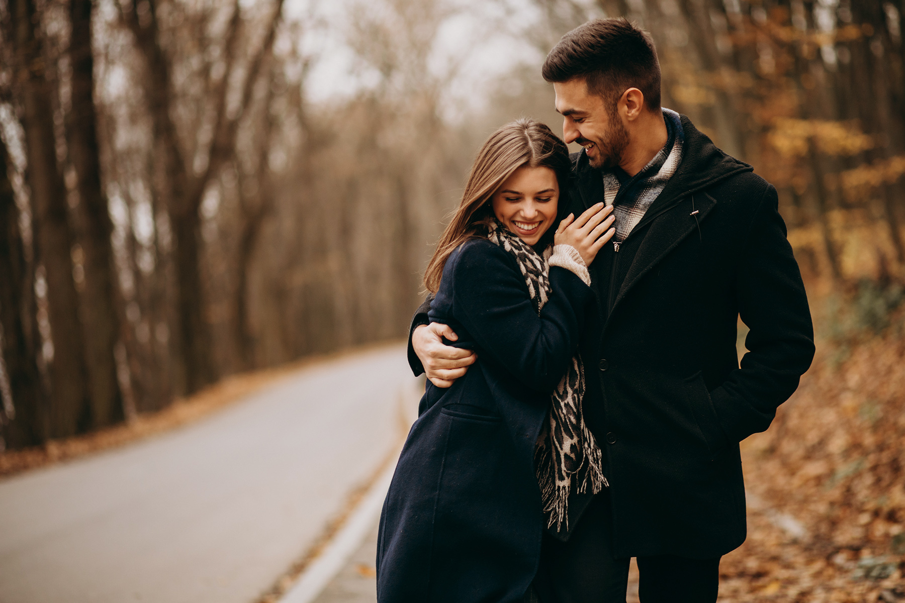 Young couple together walking in an autumn park